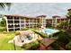 Resort-style living: stunning pool and lush landscaping create a serene oasis within the community at 6150 Gulfport S Blvd # 302, Gulfport, FL 33707