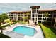 Aerial view of the community pool area with lounge chairs and manicured landscaping at 6150 Gulfport S Blvd # 302, Gulfport, FL 33707