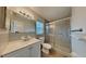Well-lit bathroom with vanity, mirror, and glass-enclosed shower at 6212 Emerson Dr, New Port Richey, FL 34653