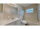 Bright bathroom featuring a vanity, mirror, toilet, and shower-tub combo at 6212 Emerson Dr, New Port Richey, FL 34653