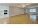 Open-concept living space with hardwood floors adjacent to a modern kitchen at 6212 Emerson Dr, New Port Richey, FL 34653