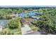 An aerial view showcases the neighborhood and property featuring a lush green lawn at 6436 Huntington Dr, Zephyrhills, FL 33542