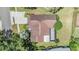 Bird's eye view of property, showcasing the roof, driveway, landscaping and screened in porch at 6436 Huntington Dr, Zephyrhills, FL 33542