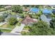 An aerial view of the house with a large lawn and screened in porch at 6436 Huntington Dr, Zephyrhills, FL 33542