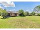 A spacious backyard with plenty of room, and an outdoor covered patio at 6436 Huntington Dr, Zephyrhills, FL 33542
