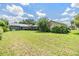 The ample backyard features mature trees and is the perfect location for outdoor activities at 6436 Huntington Dr, Zephyrhills, FL 33542