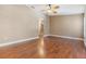 Bedroom with wood floors and doorway leading to a hallway at 6436 Huntington Dr, Zephyrhills, FL 33542