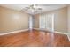 Bedroom with hardwood floors, ceiling fan, and access to the outside through glass doors at 6436 Huntington Dr, Zephyrhills, FL 33542