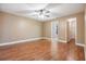 Bedroom featuring a ceiling fan, hardwood floors, and access to an adjacent room or closet at 6436 Huntington Dr, Zephyrhills, FL 33542