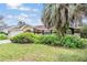 Well-manicured lawn leads to a beautiful home with an attached two-car garage at 6436 Huntington Dr, Zephyrhills, FL 33542