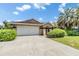 Well-manicured lawn leads to a beautiful home with an attached two-car garage at 6436 Huntington Dr, Zephyrhills, FL 33542