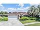 Charming single Gathering home featuring a well maintained lawn and a two car garage at 6436 Huntington Dr, Zephyrhills, FL 33542