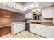 Bright kitchen featuring a skylight and stainless steel appliances at 6436 Huntington Dr, Zephyrhills, FL 33542