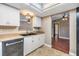 Bright kitchen featuring white cabinets, black sink and modern appliances at 6436 Huntington Dr, Zephyrhills, FL 33542