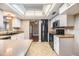Kitchen with white cabinetry, countertop lighting, black appliances, and tile floor at 6436 Huntington Dr, Zephyrhills, FL 33542
