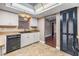 Bright kitchen with white cabinets, black appliances, and tile floors at 6436 Huntington Dr, Zephyrhills, FL 33542