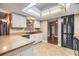 Bright kitchen featuring a skylight and stainless steel appliances at 6436 Huntington Dr, Zephyrhills, FL 33542