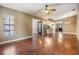 Open living room with hardwood floors connecting to the kitchen at 6436 Huntington Dr, Zephyrhills, FL 33542