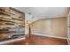 Large living room area featuring beautiful hardwood floors and unique wood accent wall at 6436 Huntington Dr, Zephyrhills, FL 33542