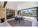 A covered outdoor patio with a glass table and chairs, and an exterior view at 6436 Huntington Dr, Zephyrhills, FL 33542
