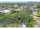 A high angle aerial shot of a tree covered property with other homes nearby at 750 Alda Ne Way, St Petersburg, FL 33704