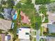 Aerial view of property with defined boundaries, pool, and lush landscaping and red-tiled roof at 750 Alda Ne Way, St Petersburg, FL 33704