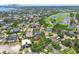 Aerial view displaying home's location near a golf course, city, and the bay, with lush landscaping at 750 Alda Ne Way, St Petersburg, FL 33704