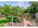 Scenic backyard featuring a quaint wooden bridge and lush, mature landscaping at 750 Alda Ne Way, St Petersburg, FL 33704