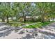 Beautiful home with large mature trees enhancing the curb appeal on a sunny day at 750 Alda Ne Way, St Petersburg, FL 33704