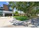 Property showcasing a landscaped front lawn, mature trees, and a modern addition next to the original home at 750 Alda Ne Way, St Petersburg, FL 33704