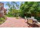 Charming brick patio with outdoor dining furniture surrounded by lush landscaping at 750 Alda Ne Way, St Petersburg, FL 33704