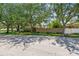 Street view of a home with mature trees providing shade and a well-maintained lawn at 750 Alda Ne Way, St Petersburg, FL 33704