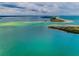 Expansive aerial view showcasing the beautiful turquoise waters surrounding the property at 8 Glencoe Pl # 305, Dunedin, FL 34698
