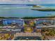 Aerial view of waterfront condos with ample parking, manicured grounds, and beautiful water views at 8 Glencoe Pl # 305, Dunedin, FL 34698