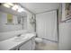 Clean bathroom featuring a shower-tub combo and a vanity sink at 8 Glencoe Pl # 305, Dunedin, FL 34698