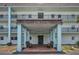 Inviting building entrance featuring a covered entryway with benches for residents and guests at 8 Glencoe Pl # 305, Dunedin, FL 34698