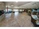 Large clubhouse with a modern fireplace, lounge area, tables, and chairs for gatherings and activities at 8 Glencoe Pl # 305, Dunedin, FL 34698