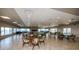 Spacious clubhouse featuring tile floors, dining tables, seating areas and a fireplace with water views at 8 Glencoe Pl # 305, Dunedin, FL 34698