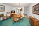Warm dining area with wood furniture, lush carpeting, and classic decor at 8 Glencoe Pl # 305, Dunedin, FL 34698