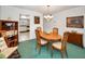 Comfortable dining space featuring wood furnishings, opening to a view of the kitchen at 8 Glencoe Pl # 305, Dunedin, FL 34698