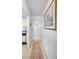 Inviting condo entrance featuring tiled floors and neutral paint colors, leading to a kitchen area at 8 Glencoe Pl # 305, Dunedin, FL 34698