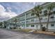 Condominium complex showing private balconies and a welcoming entrance area with seating at 8 Glencoe Pl # 305, Dunedin, FL 34698