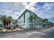 Well-maintained building with balconies and a landscaped patio area for residents to enjoy at 8 Glencoe Pl # 305, Dunedin, FL 34698