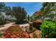 Enjoy the lush landscaping of this community space that features a fountain surrounded by colorful flower bushes at 8 Glencoe Pl # 305, Dunedin, FL 34698