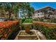 Enjoy this green space featuring a community fountain surrounded by vibrant flower bushes and tropical plants at 8 Glencoe Pl # 305, Dunedin, FL 34698