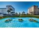 Beautiful fountain with dolphin statues set against the backdrop of well-maintained apartment buildings at 8 Glencoe Pl # 305, Dunedin, FL 34698