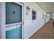 Exterior hallway view with the entrance to unit 305, showcasing outdoor lighting and secure doorway at 8 Glencoe Pl # 305, Dunedin, FL 34698
