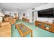 Open-concept living room leading to the kitchen, dining area, and bathroom at 8 Glencoe Pl # 305, Dunedin, FL 34698