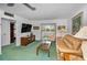 Cozy living room providing a glimpse of the view with comfortable seating and decor at 8 Glencoe Pl # 305, Dunedin, FL 34698