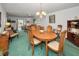 Comfortable living and dining area featuring wood furnishings and an open layout at 8 Glencoe Pl # 305, Dunedin, FL 34698